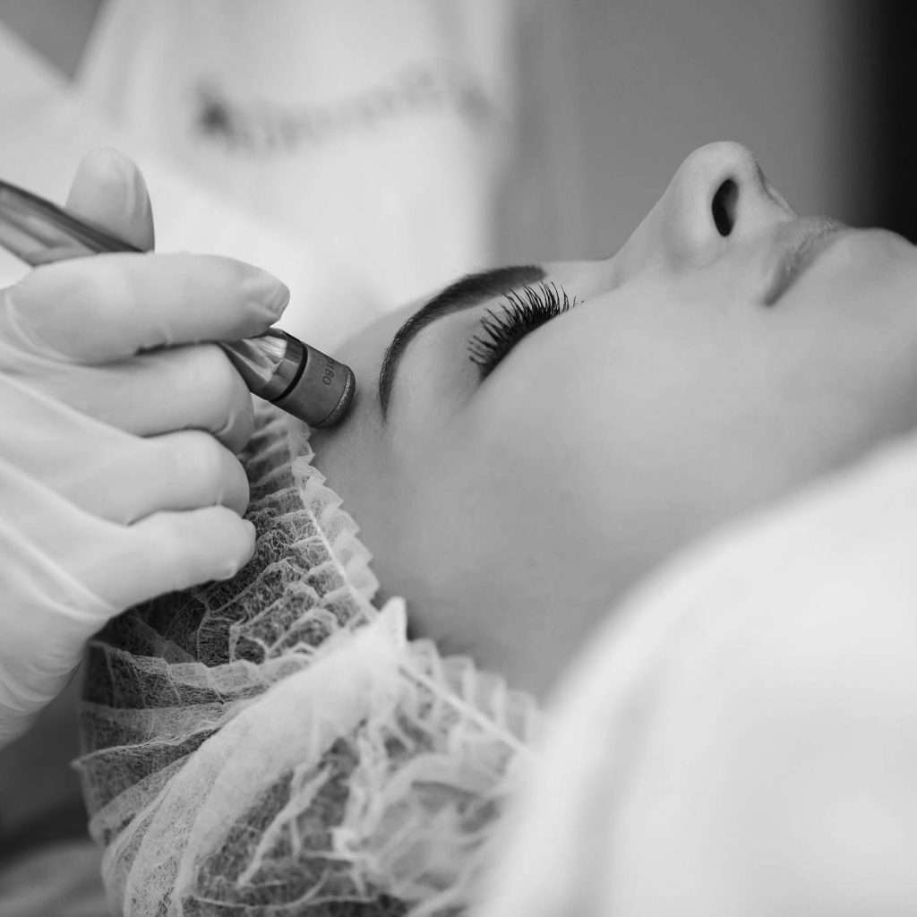 Woman receiving facial treatment
